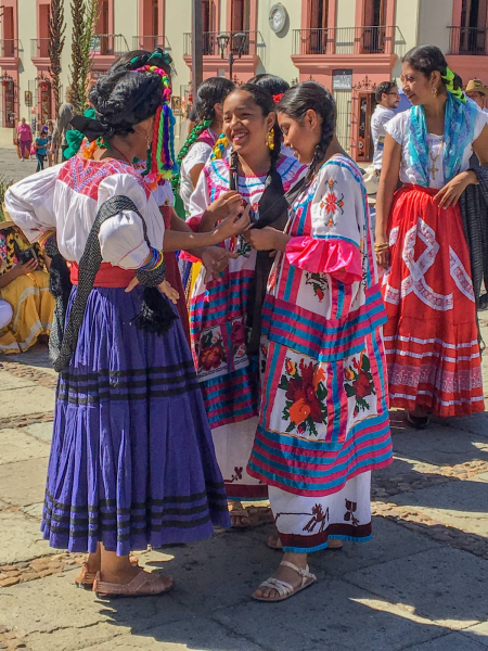 Dancers in the traditional dress of villages near Oaxaca wait to perform for a wedding at Santo Domingo church