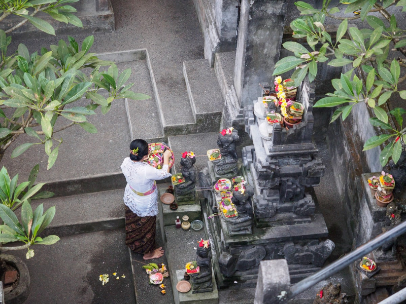 We watched from a bridge as this woman conducted a private ritual with offerings at a neighborhood shrine