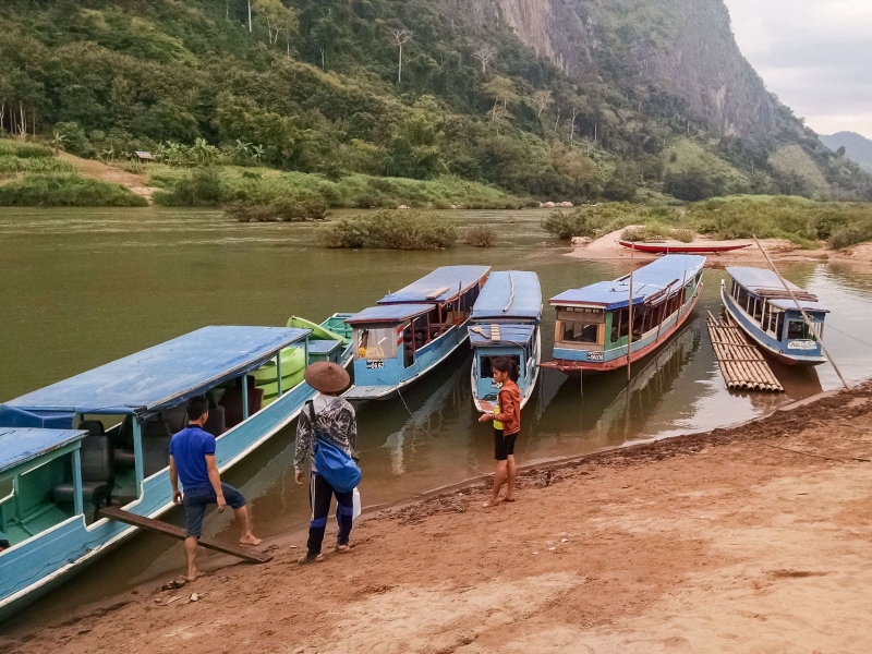 Boarding a boat for our trip up the Nam Ou river (with green kayaks in the back for kayaking back down the river)