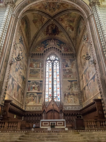 The main altar has wooden choir stalls, stained glass windows, and wall paintings all from the 14th century
