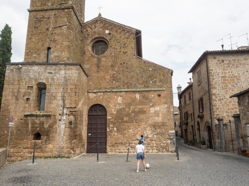Kids play soccer outside the oldest church in Orvieto, the 11th-century church of San Giovenale