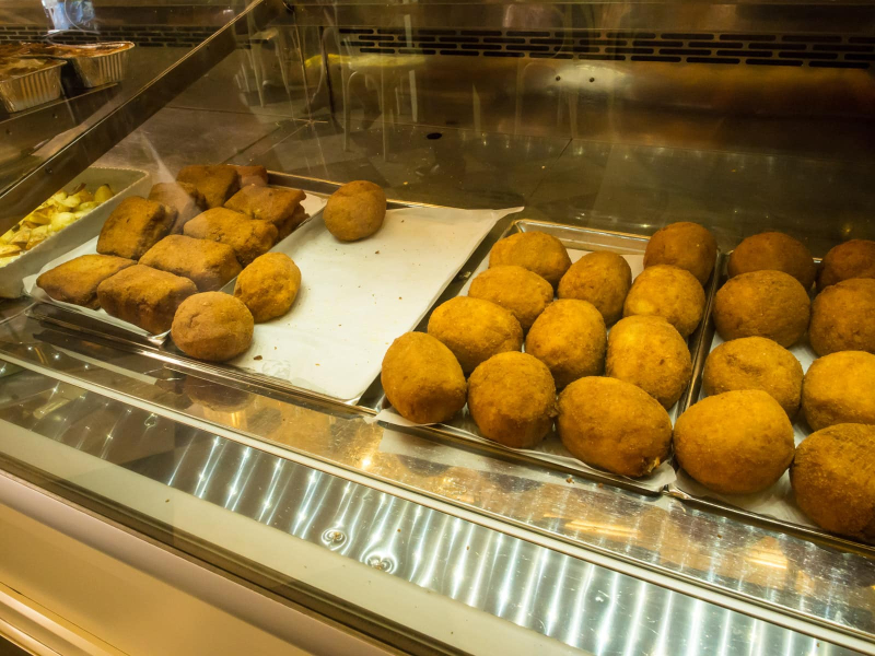Another Sicilian specialty is huge arancini (balls of yellow saffron rice stuffed with meat, cheese, or vegetables and fried)
