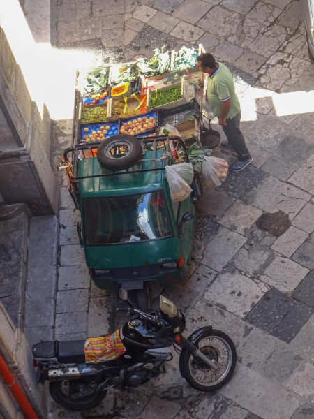 A fruit vendor on the street below