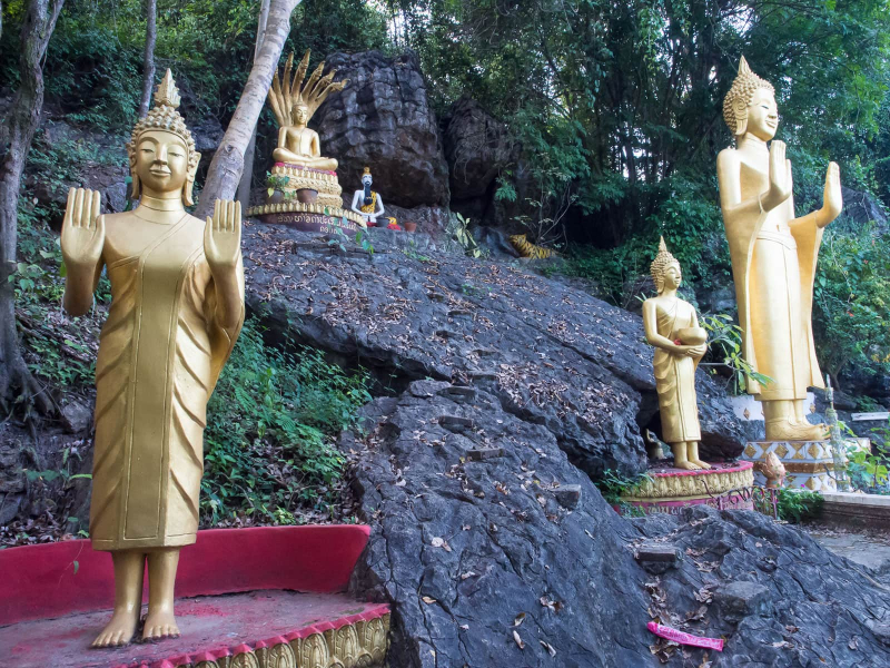 On the other side of the hill from the old temple, steps wind through a current monastery and a series of Buddhas set among the rocky slopes