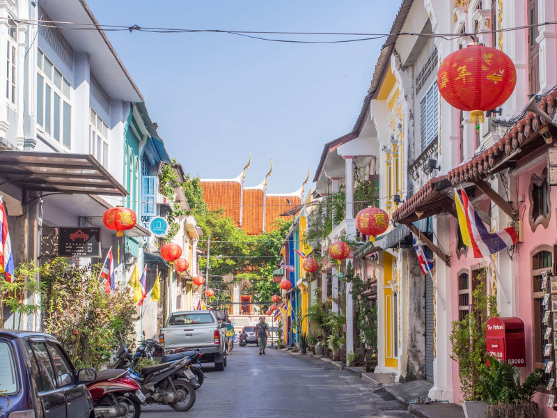 A mix of cultures in Phuket town: A street of old Chinese shophouses leads to a Thai Buddhist temple, with its characteristic golden roof finials