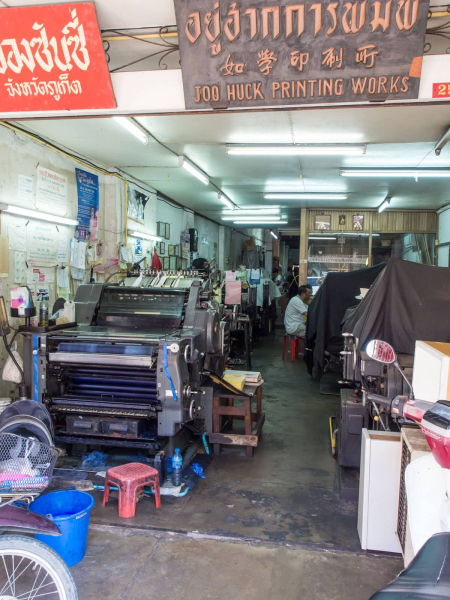 Some shophouses are hotels, restaurants, homes, or stores; others are industrial sites, like this printing shop.
