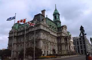 Montreal's City Hall, built in the 1870s, flying the flags of Quebec Province, Canada, and Montreal