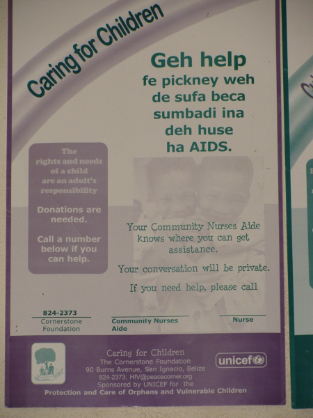 Health posters in a bus station show some of Belize's many languages: Kriol (an English-based creole) . . .