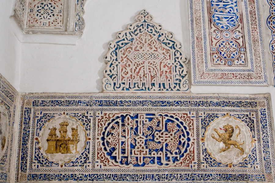The emblems of Christian Castille and Leon mix with Moorish carving in the Alcazar