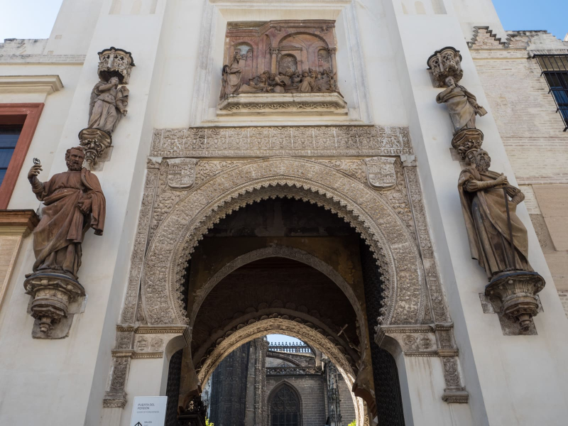 Like many churches in southern Spain, the cathedral in Seville was built on the location of a former mosque. In this entry way, Christian saints flank a Moorish-style arch.