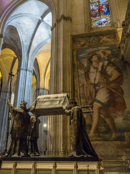 The tomb in front of a huge painting of Columbus as St. Christopher, carrying the Christ child over oceans