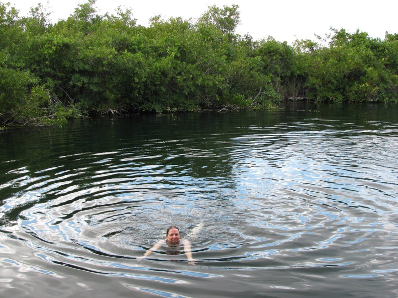 Chris swimming in the pleasantly cool waters of a cenote near the entrance to the reserve