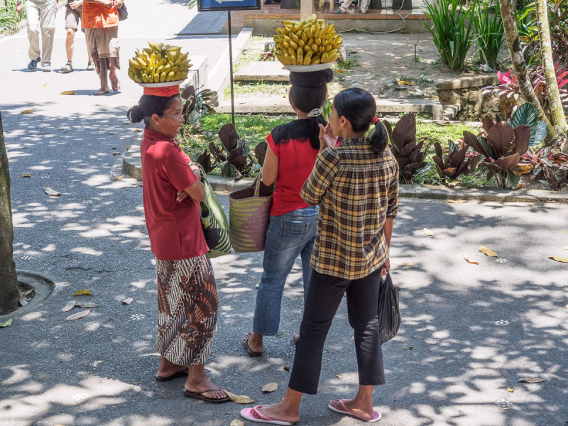 Women sell bananas outside the site