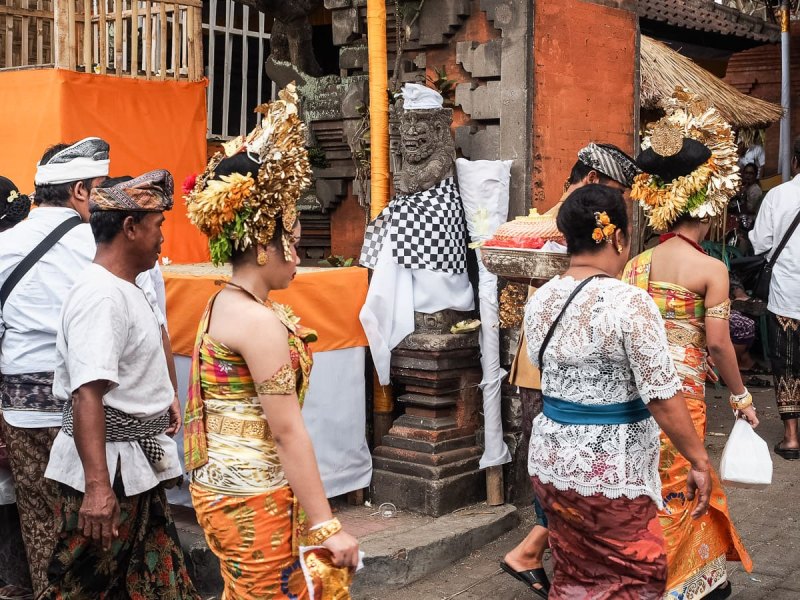 The most elaborately dressed people, many with head dresses, are the ones undergoing the ritual