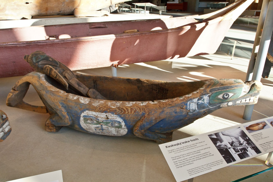 A large ceremonial feast bowl (with a full-size canoe behind it for scale)