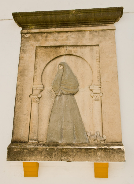 Plaque on a church showing traditional women's dress in Vejer.
