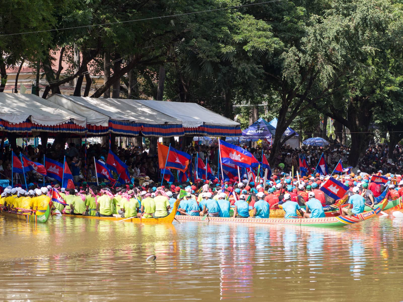 Boats and their crews wait by the grandstand while officials make long speeches at the beginning of the festival