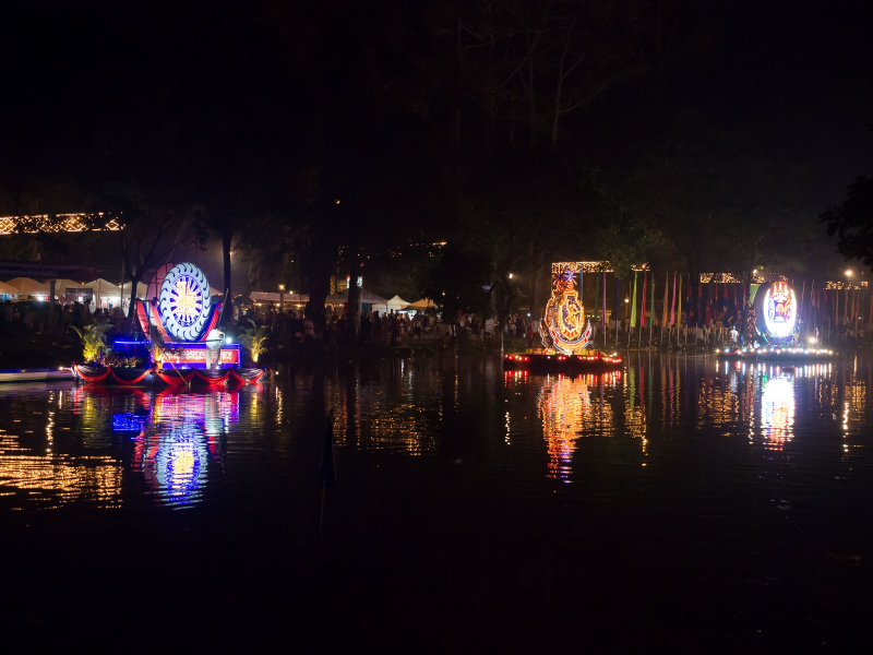 The floats moored to the river bank were brightly lit at night