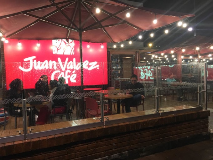 People sitting outside a Juan Valdez Cafe