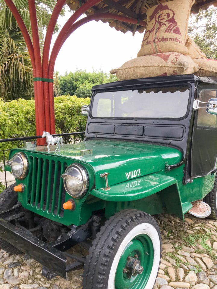 Green Willys jeep with coffee bags on top