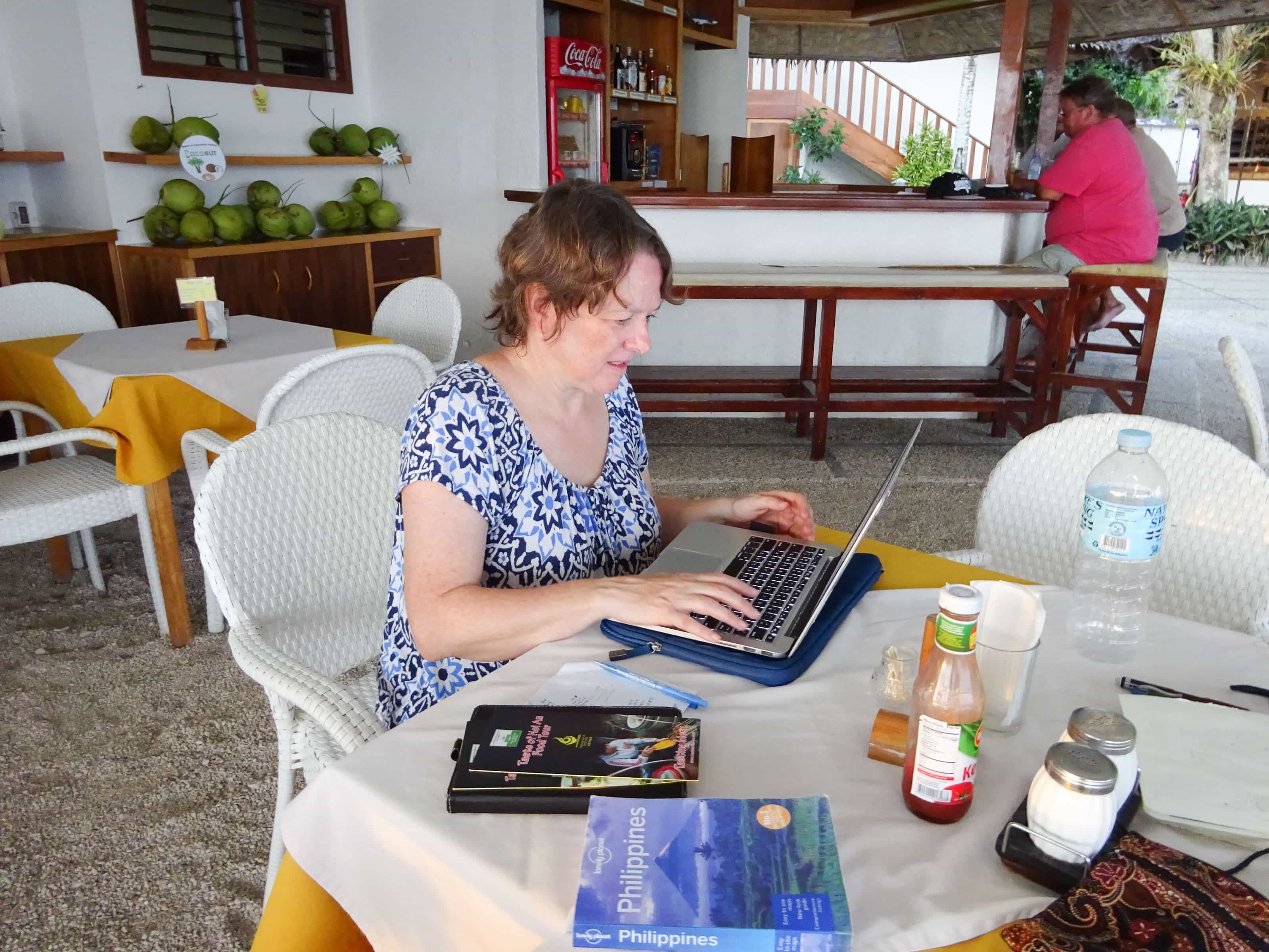 Chris working on laptop at outdoor table