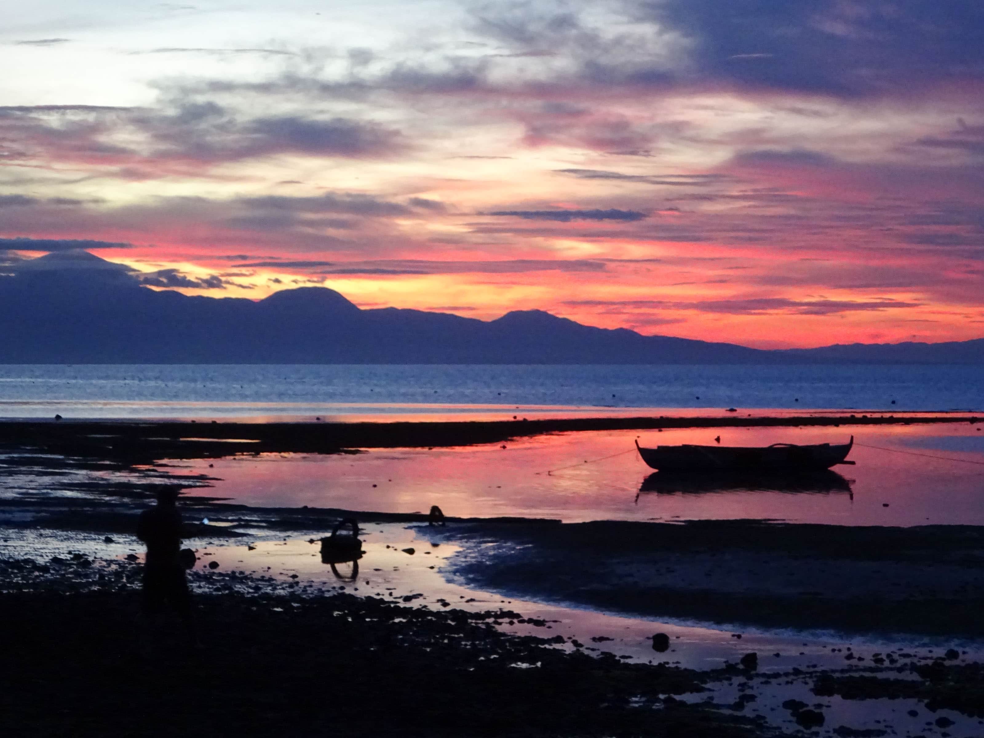 Orange, pink, blue sunset over shore on Siquijor