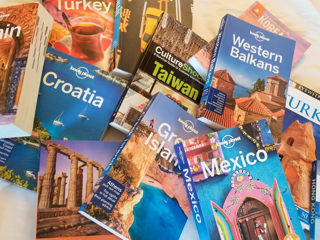 Piles of different travel guides