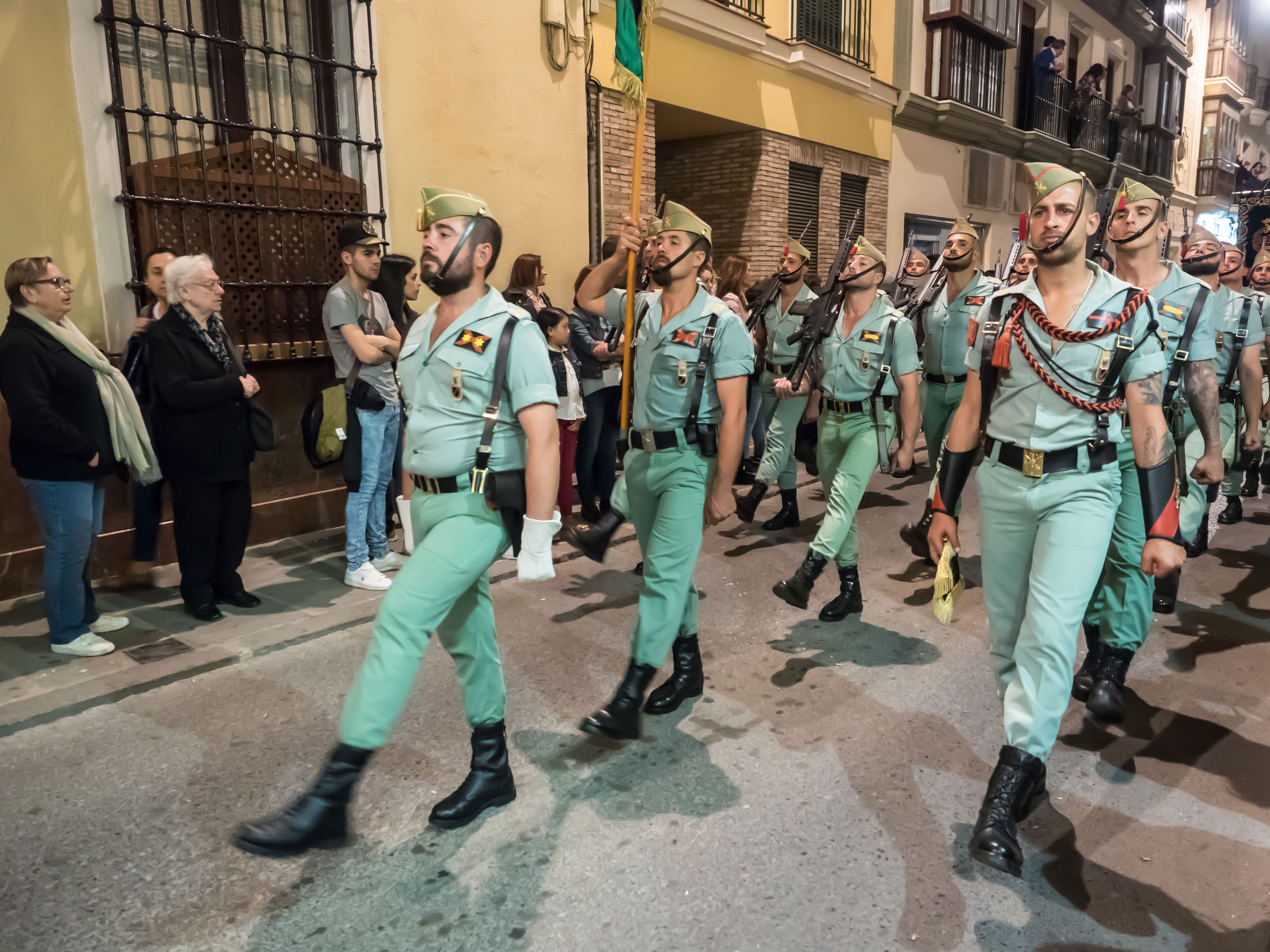 Members of Spanish Legion march in green uniforms with rifles