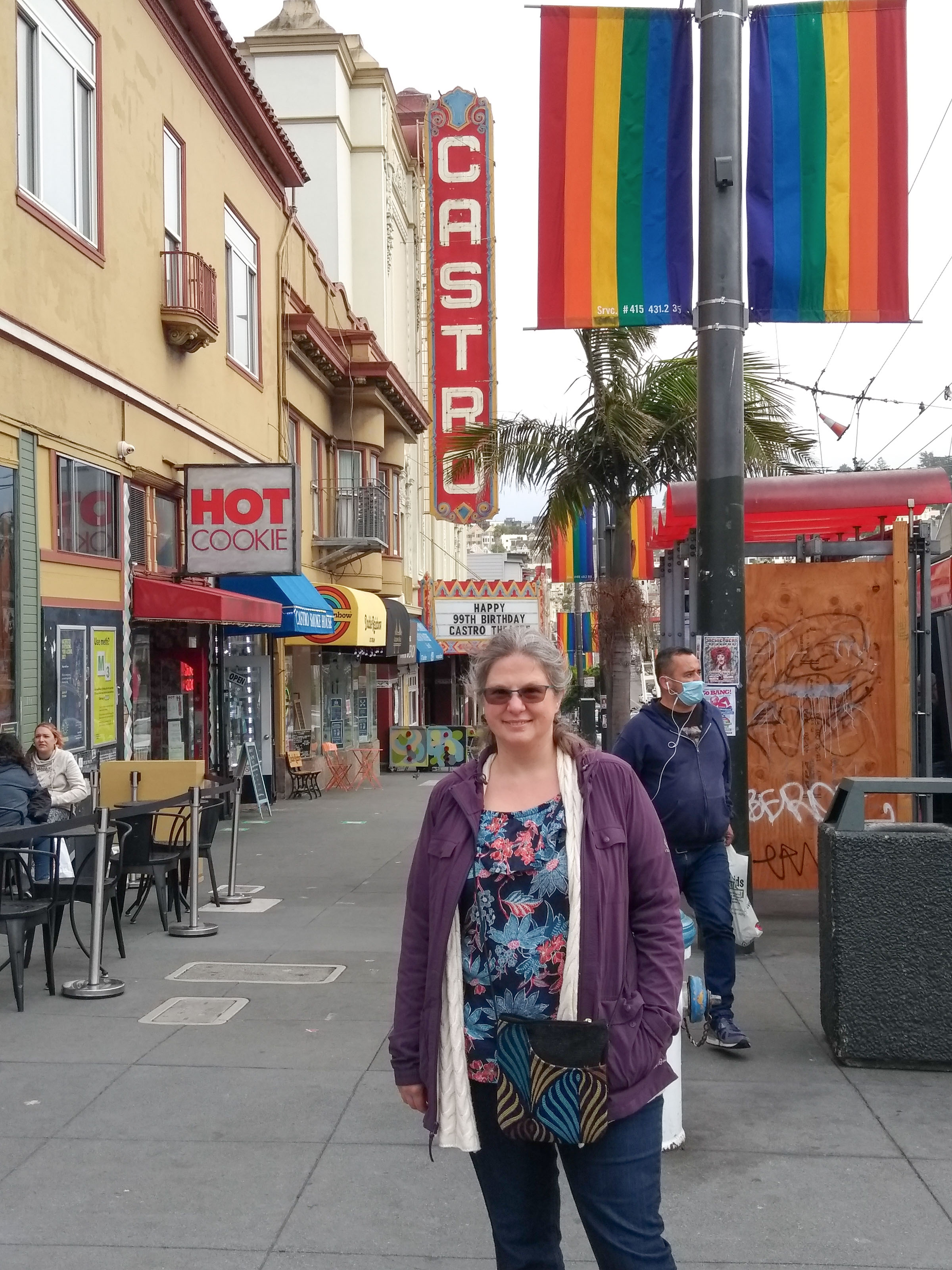 Melissa in front of pride flags and Castro Theater