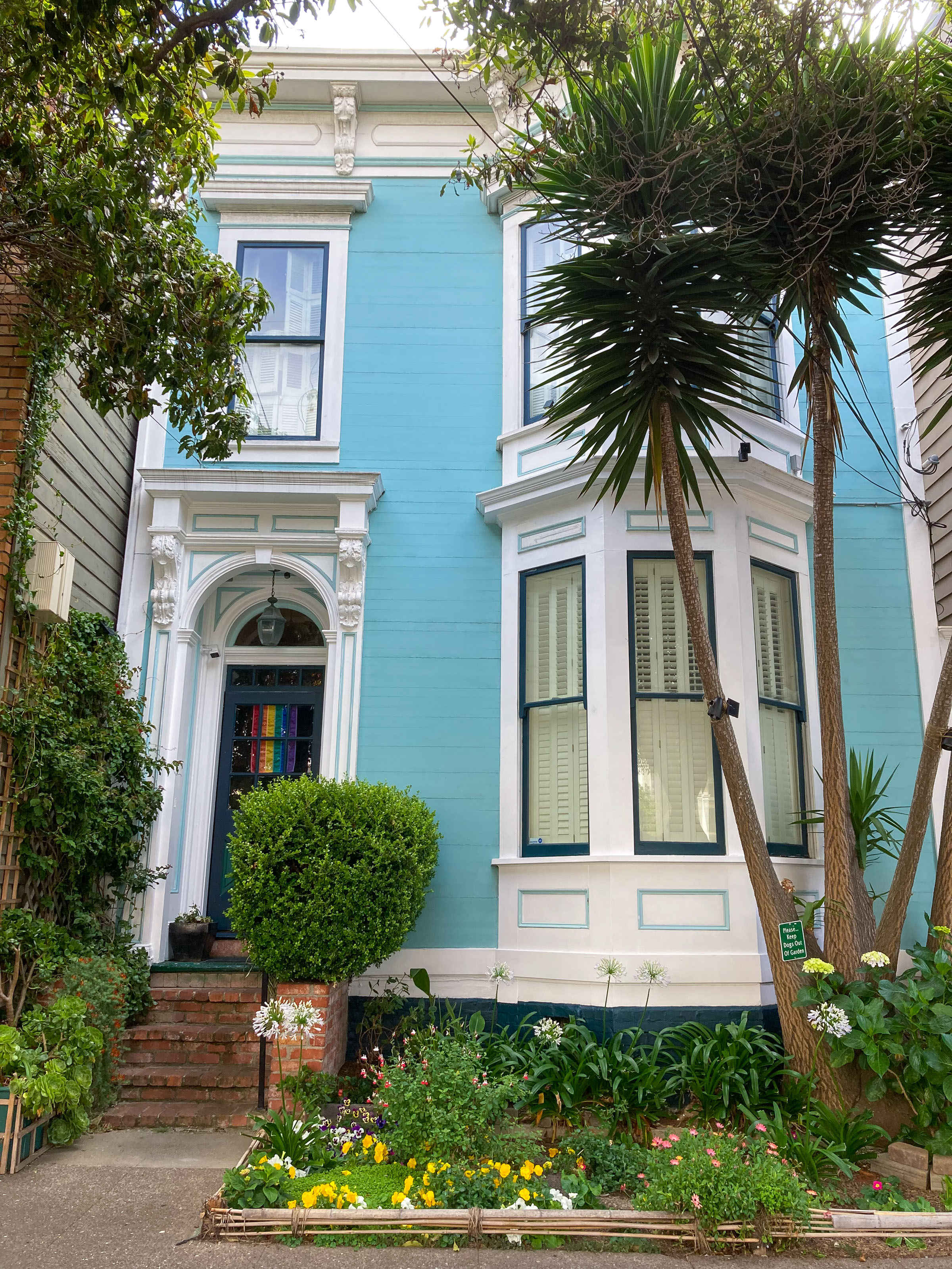Aqua-colored house and front garden