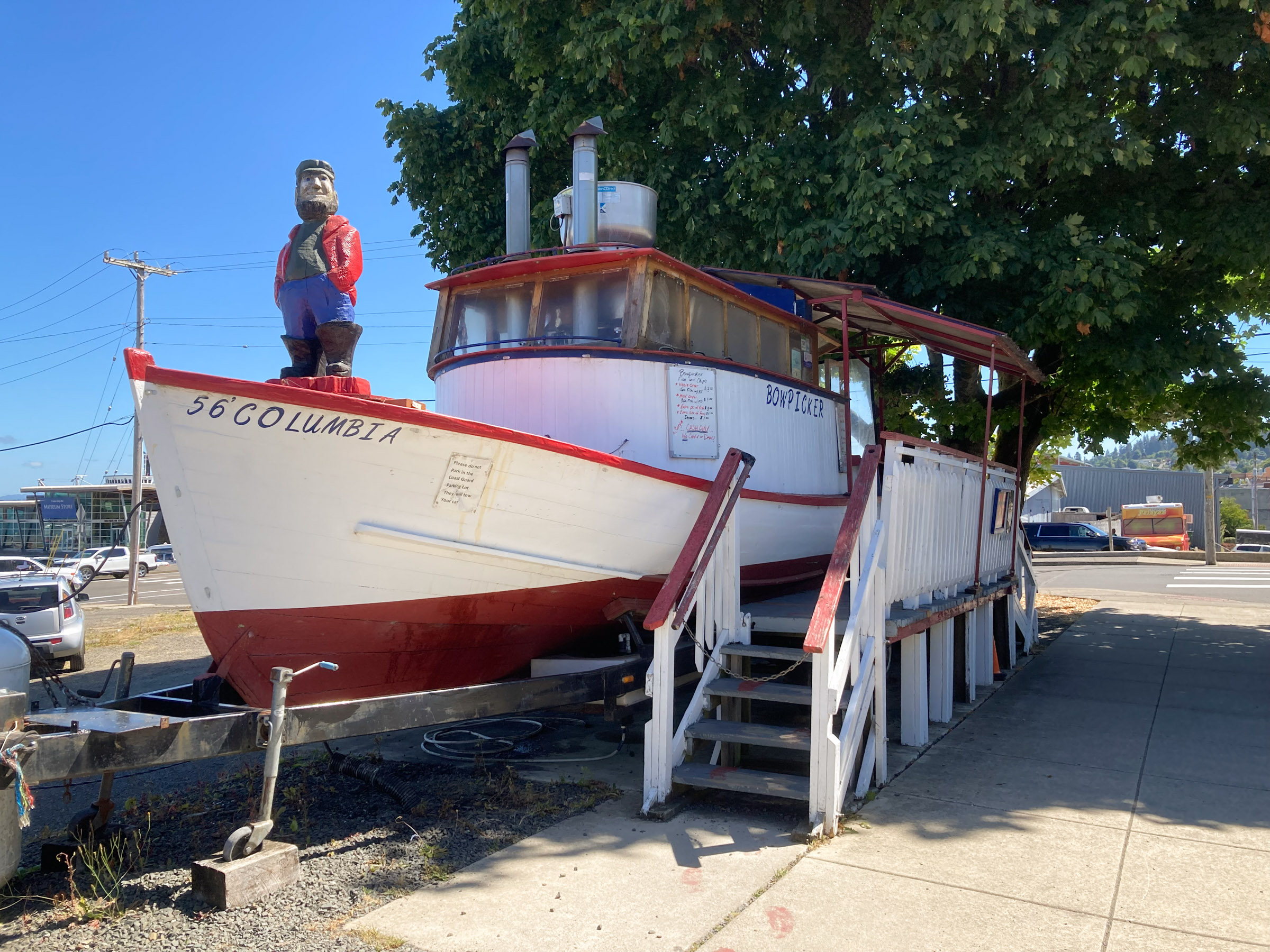 Red and white boat in a parking lot