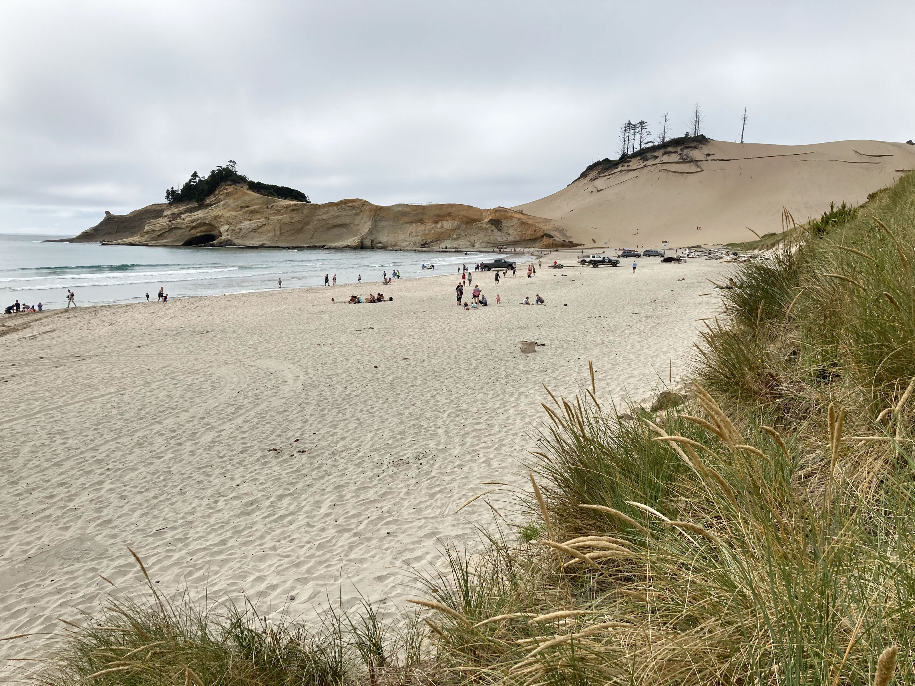 Sandy beach with high dune at the end