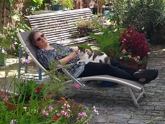 Melissa in a lawn chair with a cat on her lap