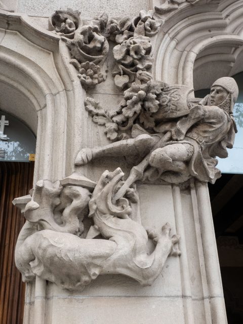 Carving of St. George killing a dragon on a building
