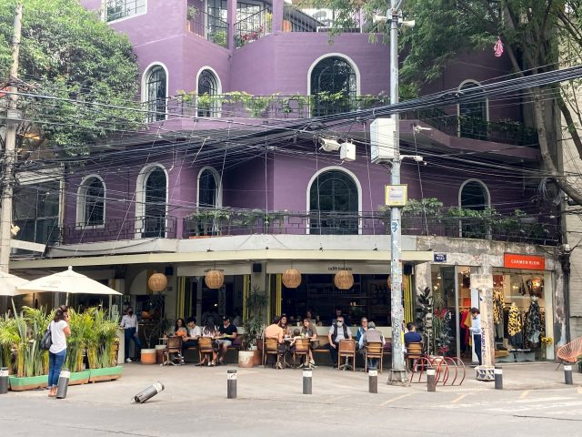 Purple building with sidewalk cafe on the ground floor