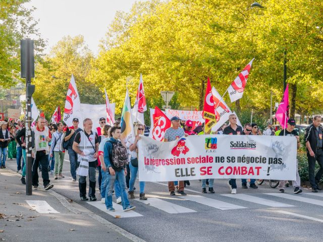 Trade union demonstrators in Annecy with flags and a banner