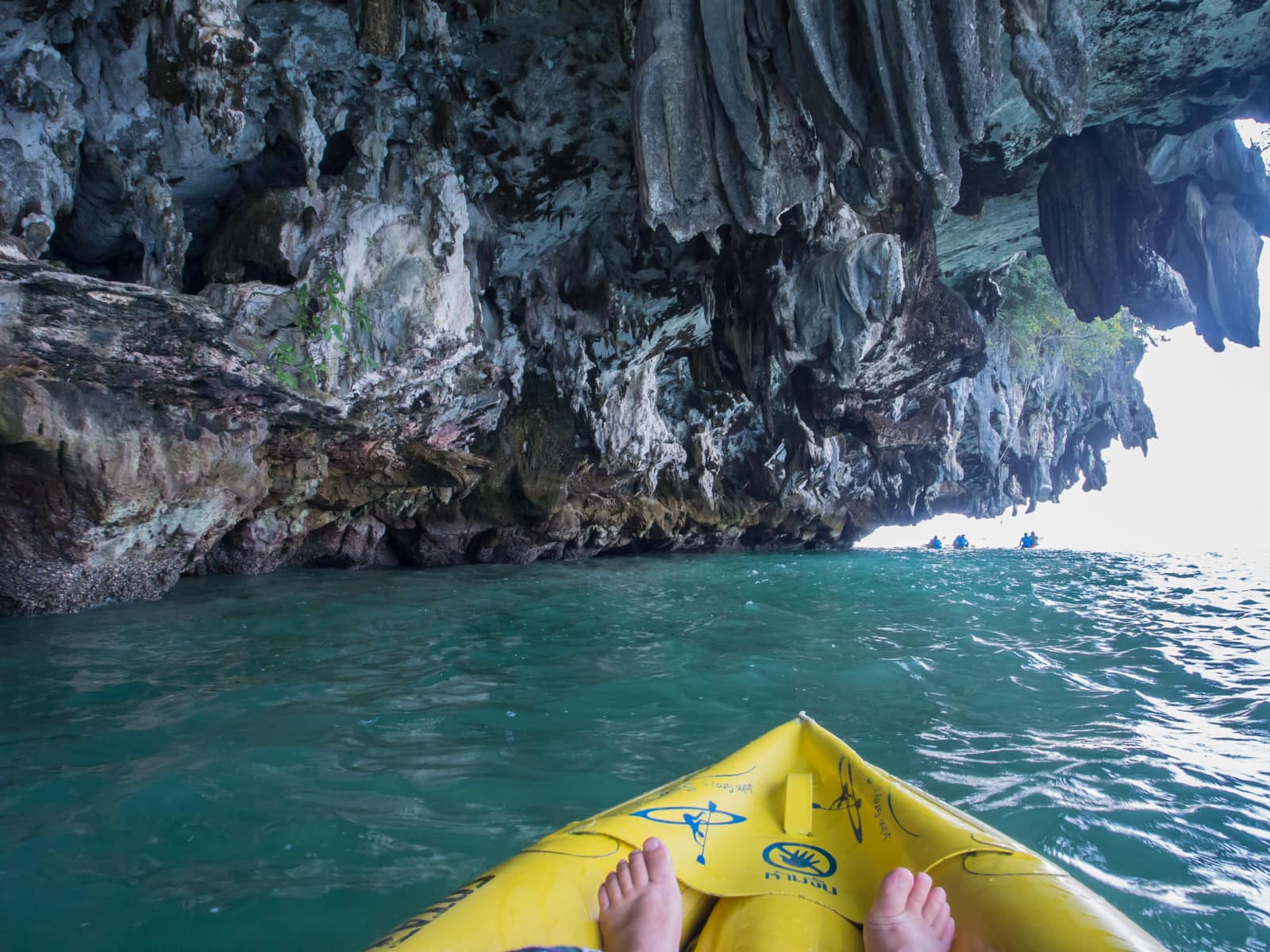 End of yellow kayak under cave overhang